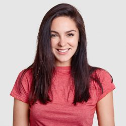 woman-with-pleasant-smile-dark-hair-dressed-casual-pink-t-shirt-has-white-perfect-teeth-rejoices-receiving-compliment